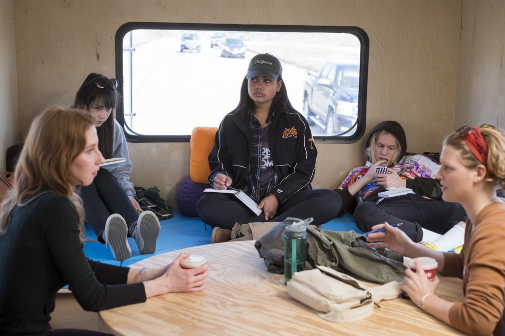 Writer Kendra Atleework talks with students on the RV
