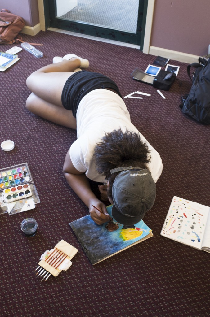 Brooklyn Jarrett works on painting for exhibition