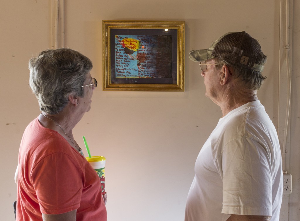 Exhibition visitors admire Brooklyn Jarrett's painting